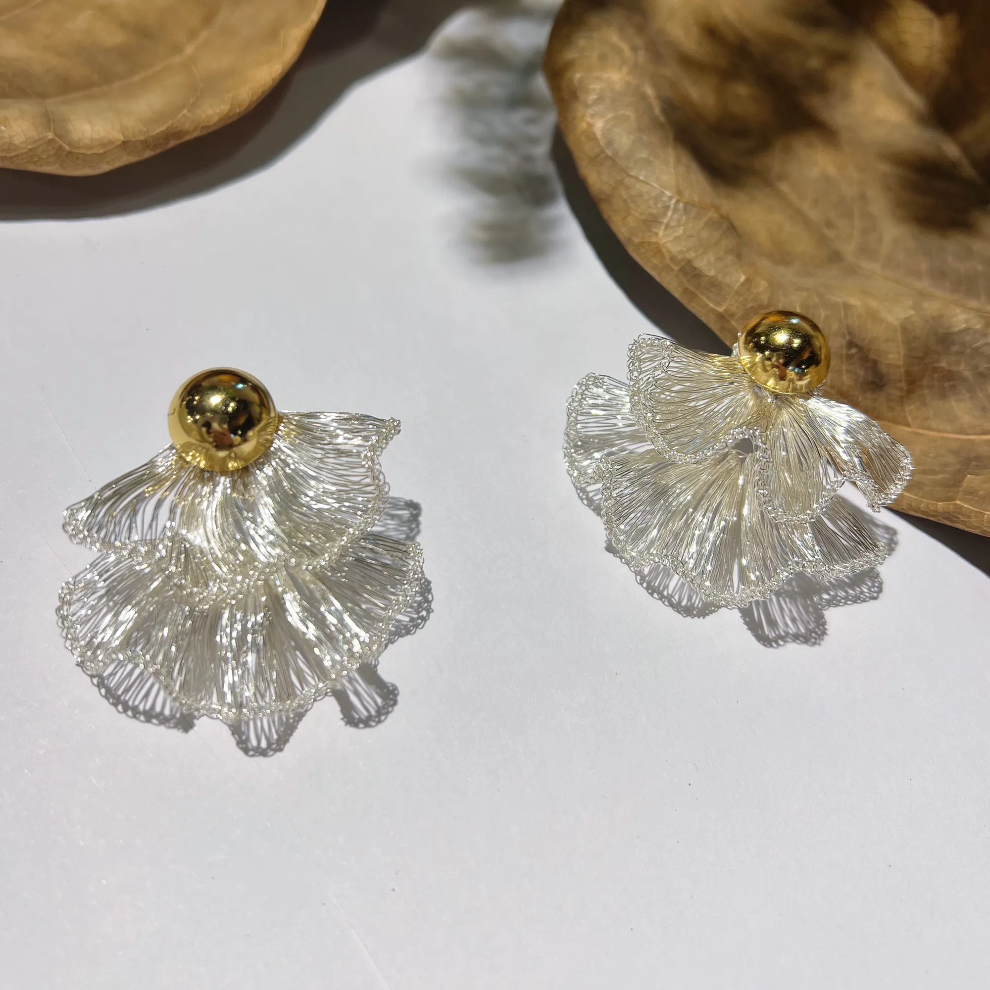 Pair of handwoven silver-tone layered fan statement earrings