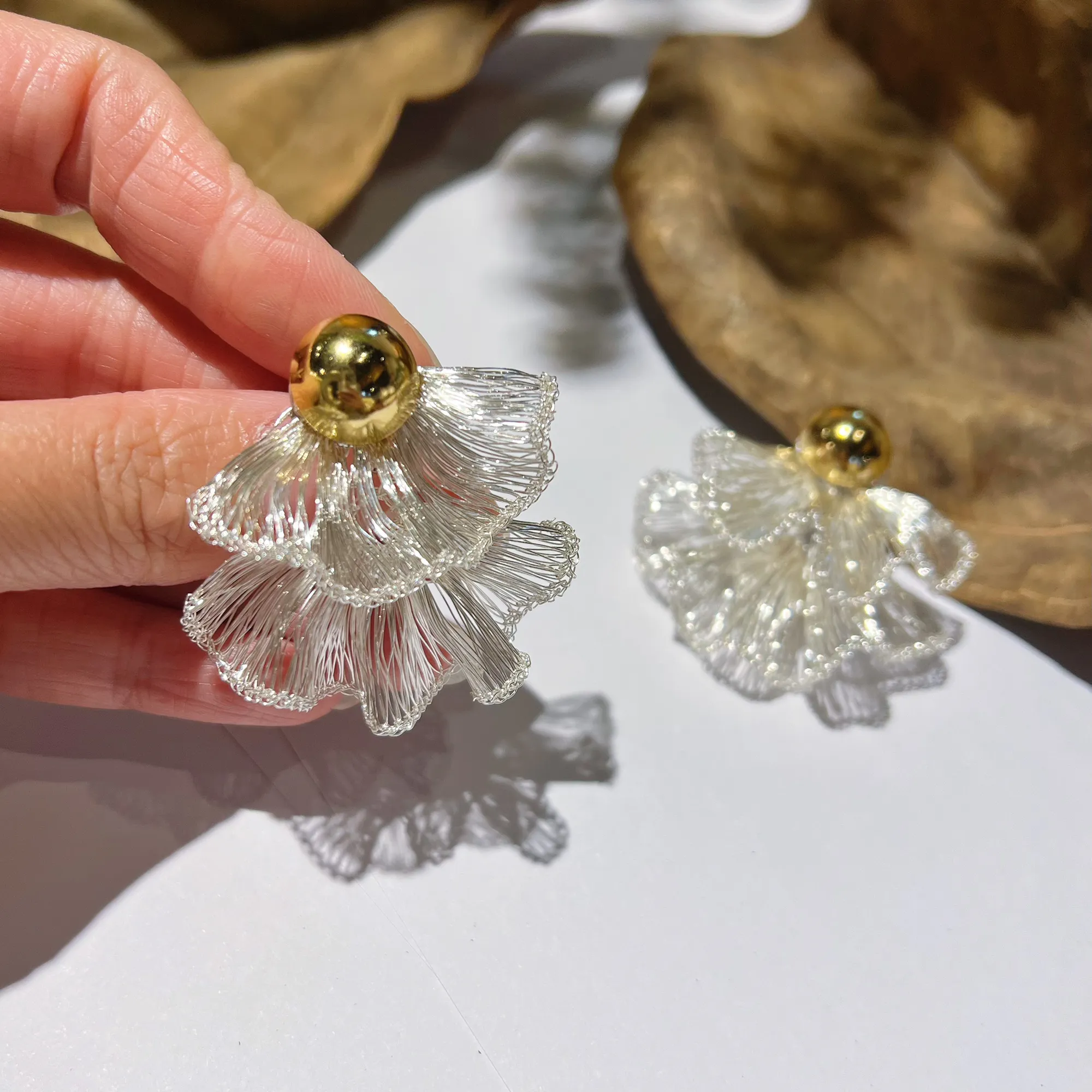 Layered silver-tone wire fan earrings with overlapping sculptural forms