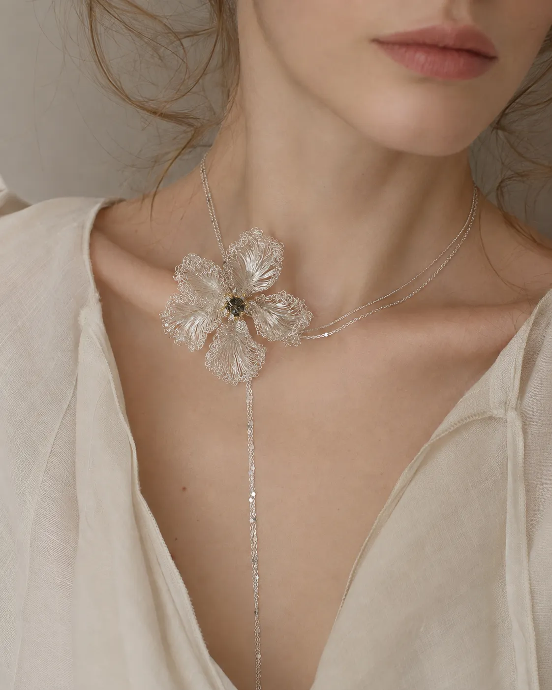 Model wearing the OREYNE White Musk Mallow sculptural flower necklace