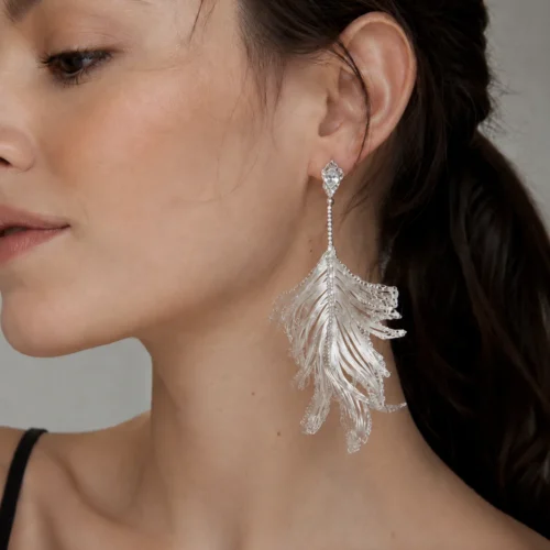 Model wearing OREYNE Skeleton Leaf drop earrings