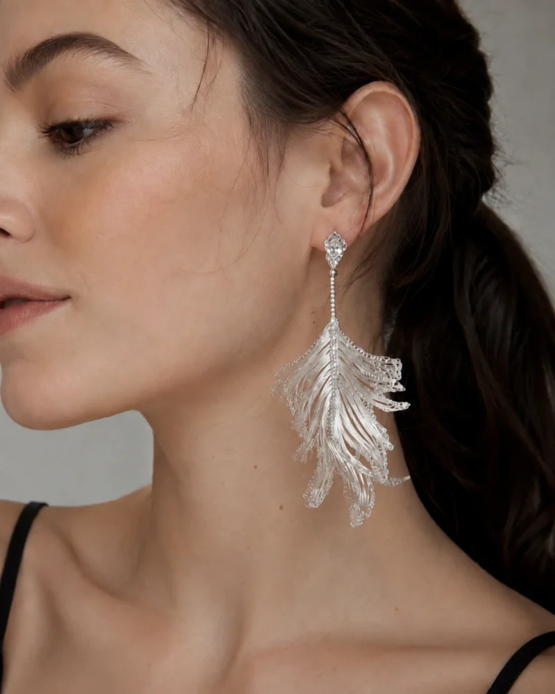 Model wearing OREYNE Skeleton Leaf drop earrings