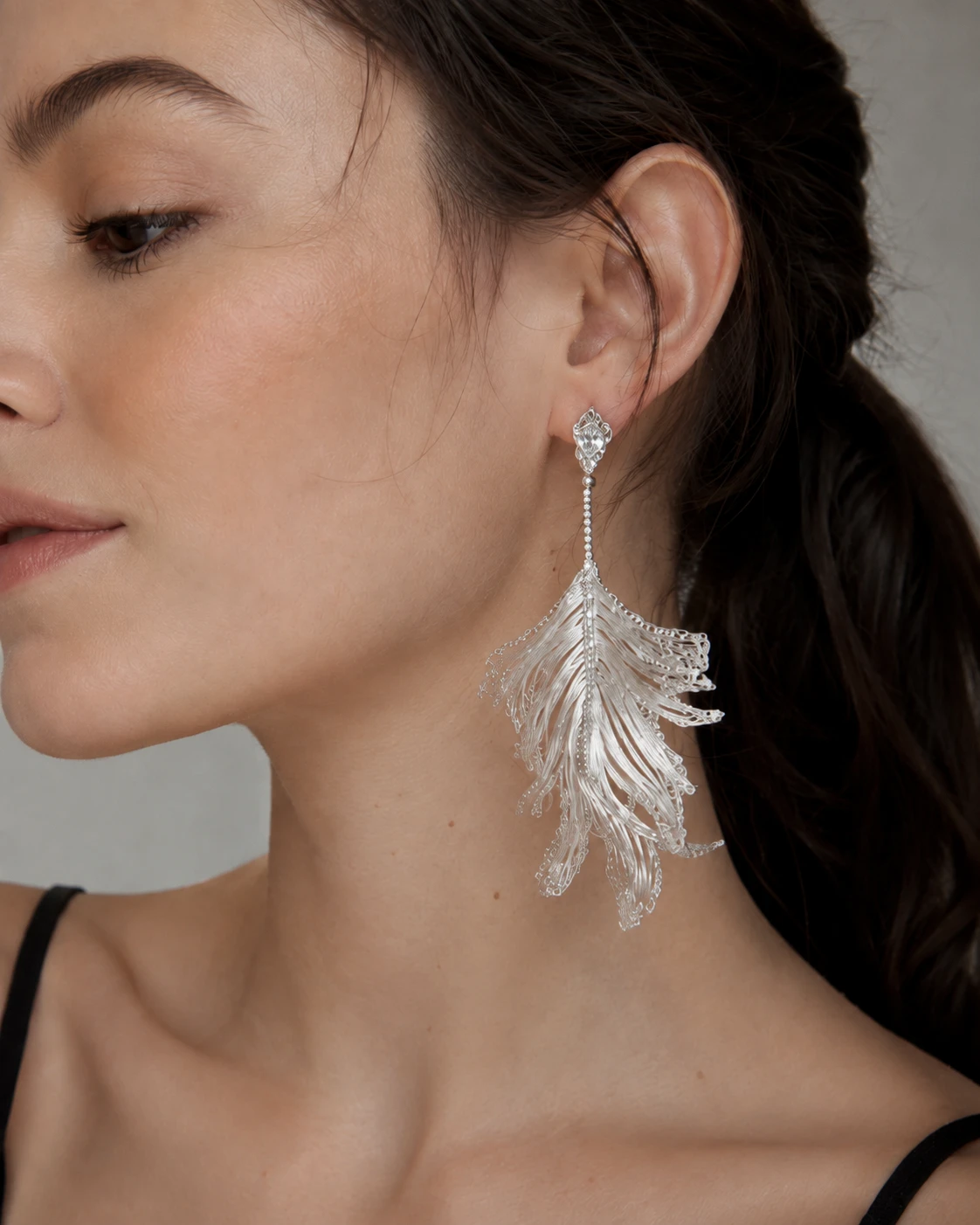 Model wearing OREYNE Skeleton Leaf sculptural drop earrings