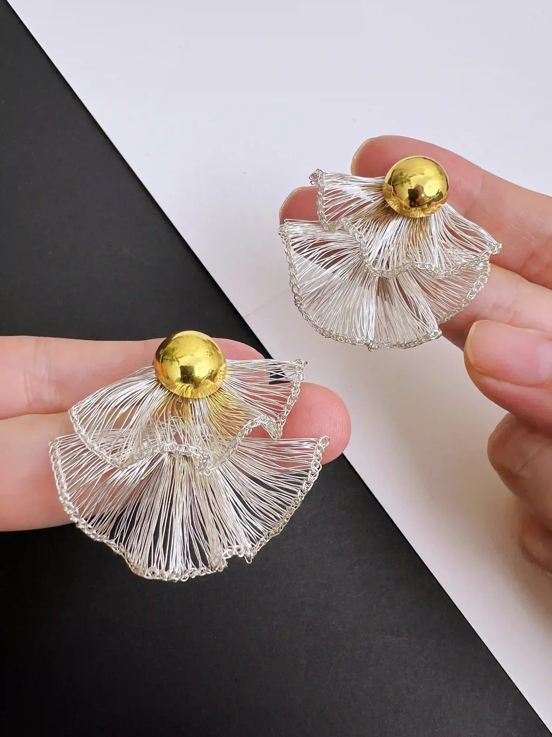 Close-up of handmade silver-tone layered fan earrings with gold-tone ball studs