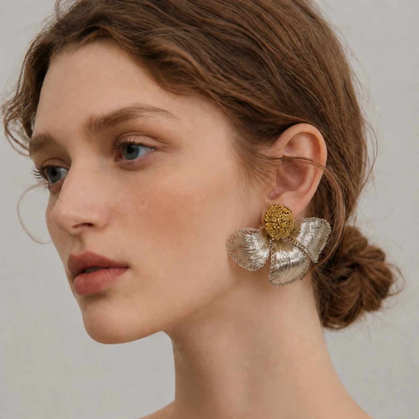 Woman wearing a handmade openwork flower statement earring