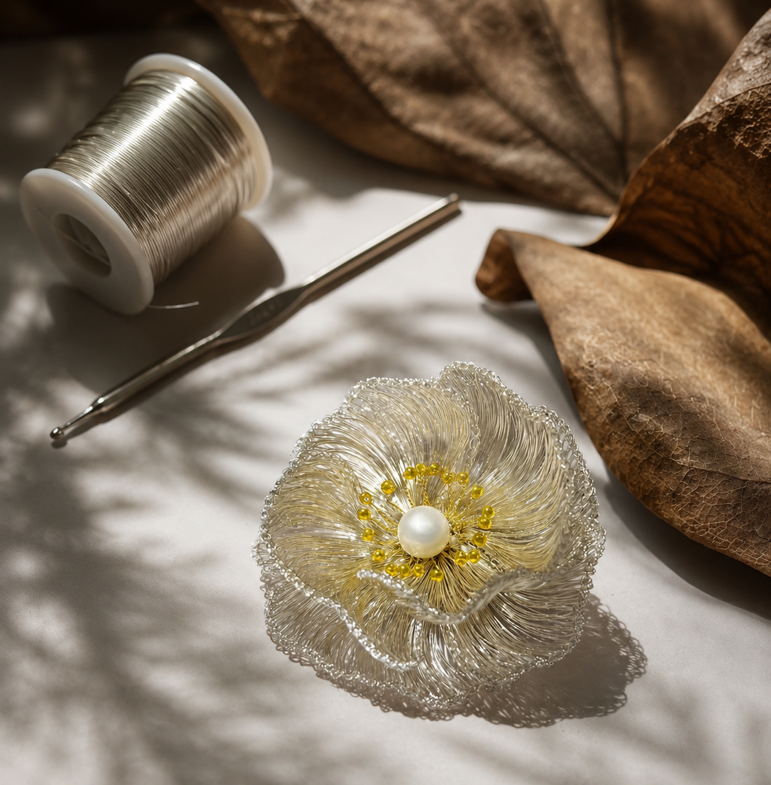 Handwoven metal flower brooch with wire, craft tools and sculptural detail