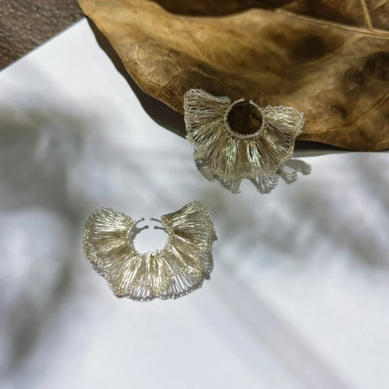 Front view of handwoven Fine Silver-Plated Copper Wire hoop earrings with repeated fan-shaped sections