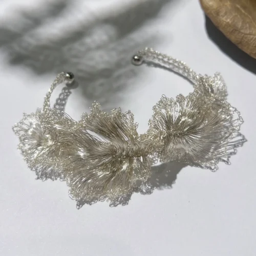 Handwoven silver-tone wire floral cuff bracelet with layered sculptural forms