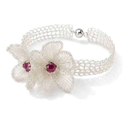 OREYNE handcrafted silver wire floral bracelet with pink stone centers on a white background