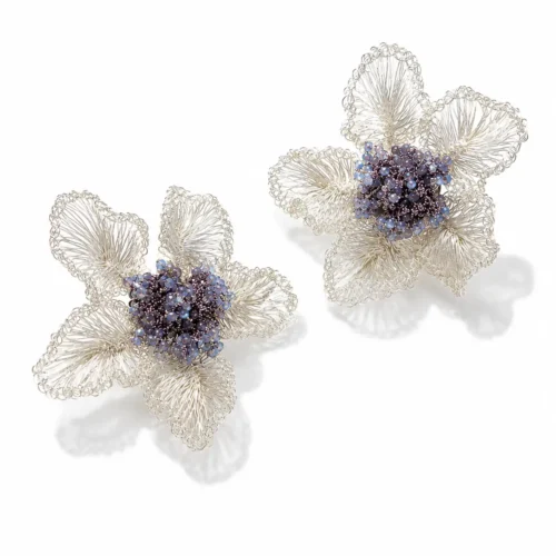 OREYNE handcrafted silver wire flower earrings with blue and violet beaded centers on a white background