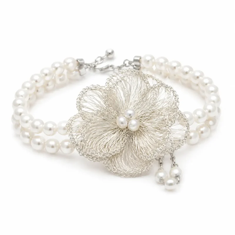 OREYNE handcrafted silver wire flower bracelet with pearl details on a white background