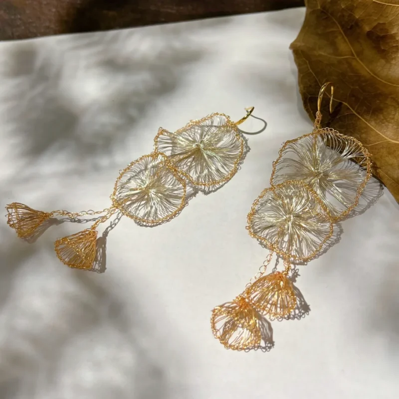 OREYNE gold-tone Morning Glory petal tassel earrings natural flat lay