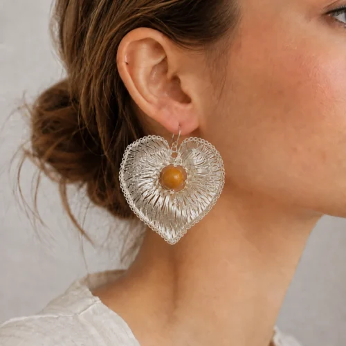 Model wearing OREYNE Pink Morning Glory heart drop earrings