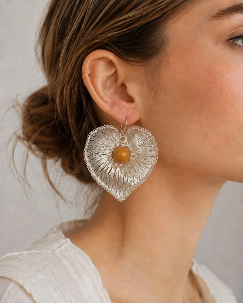 Model wearing OREYNE Pink Morning Glory heart drop earrings