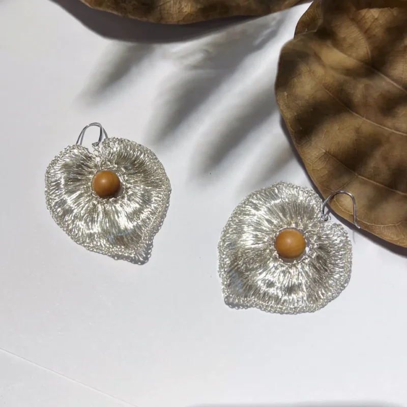 OREYNE handwoven silver-tone heart earrings in natural light