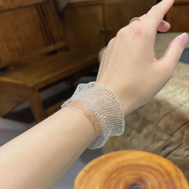 Side view of OREYNE handwoven silver-tone mesh bracelet worn on wrist