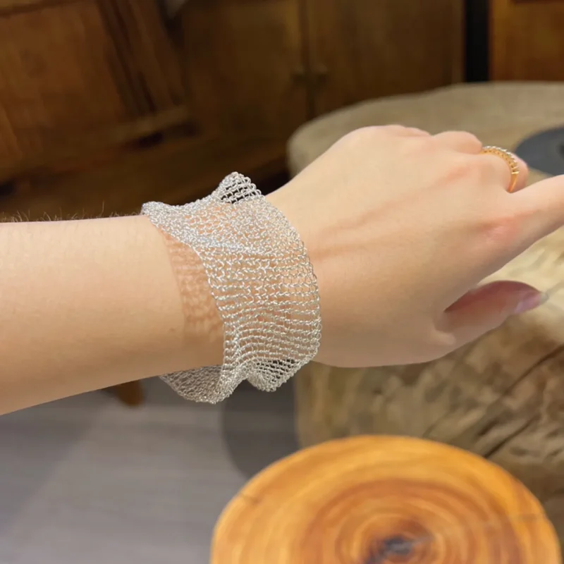 Close-up of an OREYNE sculptural mesh cuff bracelet woven from Fine Silver-Plated Copper Wire