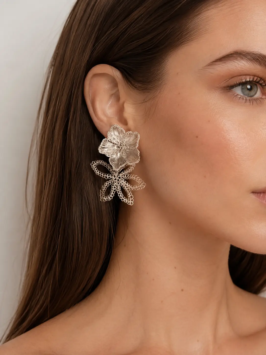 Woman wearing OREYNE silver-tone Water Lily double flower earrings