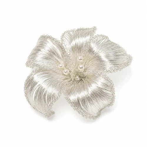 OREYNE silver-tone handwoven wire flower brooch with pearl accents on white background
