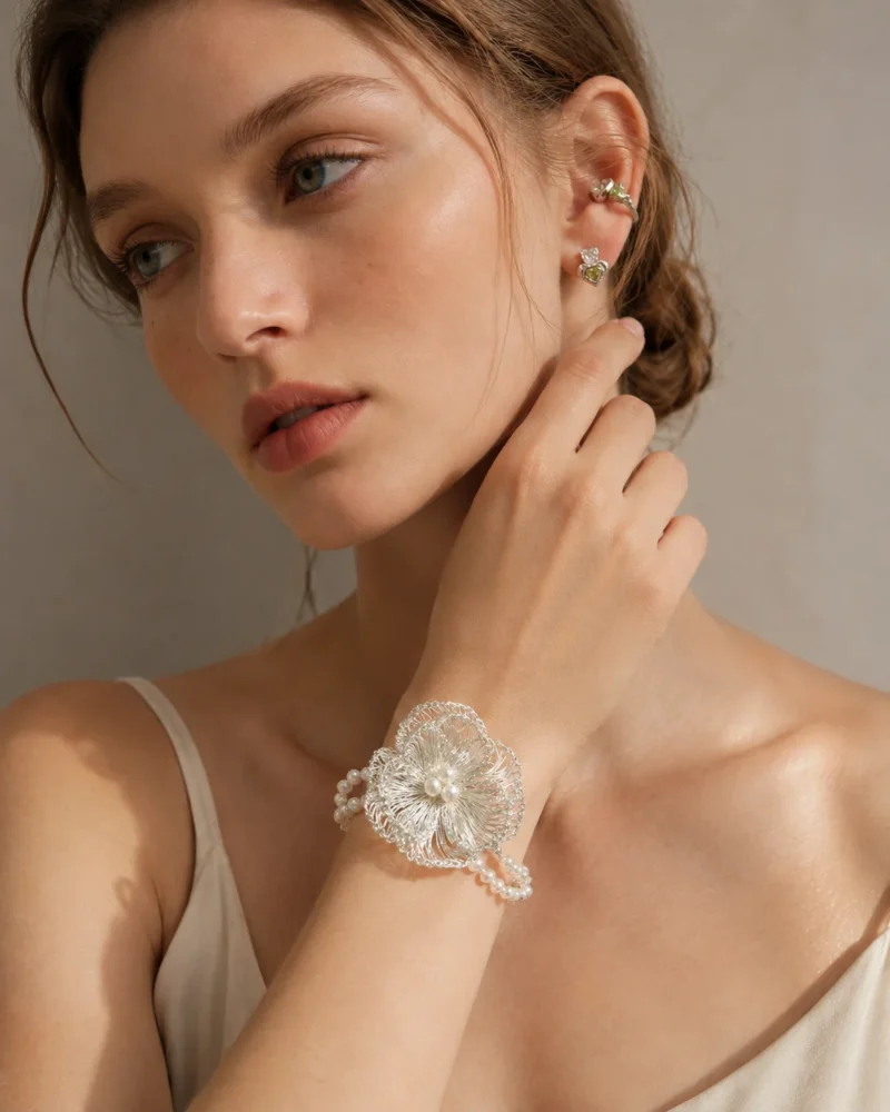 Model wearing OREYNE handcrafted silver wire pearl flower bracelet