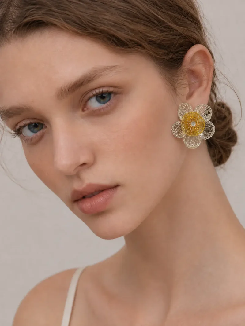 Side view of woman wearing OREYNE sculptural Golden Coreopsis earrings