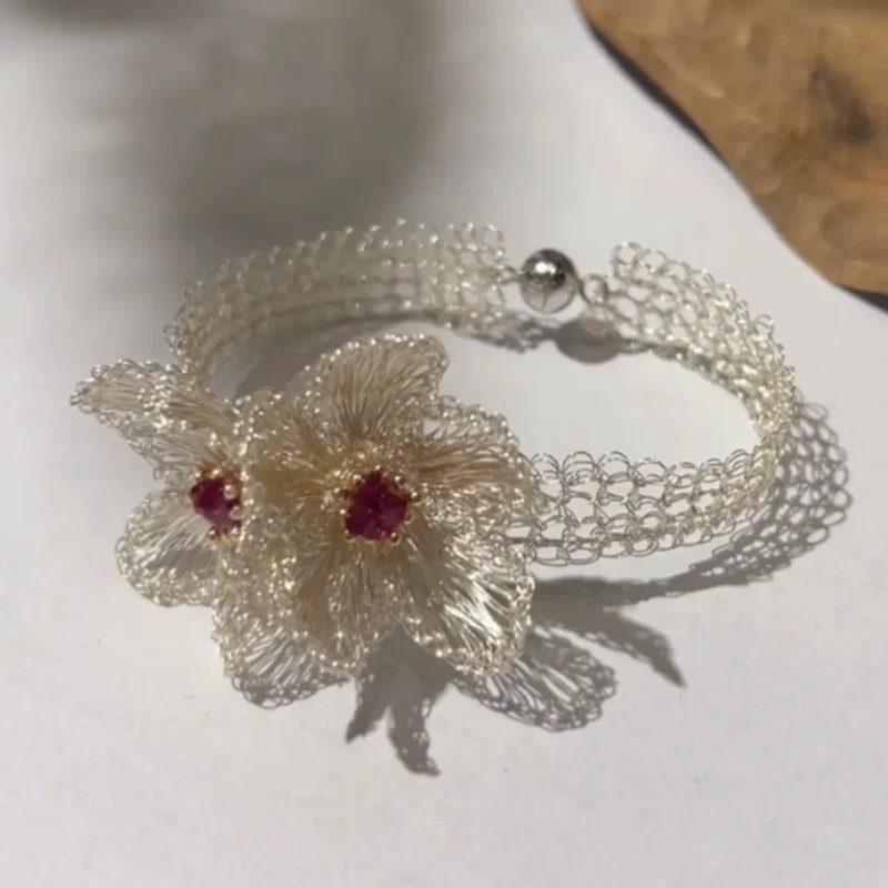 Sculptural floral bracelet crafted from Fine Silver-Plated Copper Wire with magenta accents