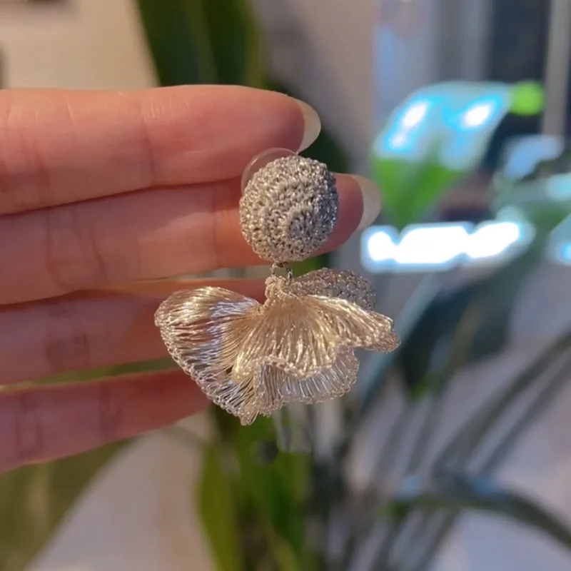 Pair of Elara Fold silver-tone handwoven sculptural drop earrings front view