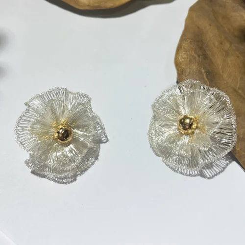 Pair of silver-tone handwoven wire flower statement earrings with layered petals and gold-tone centers