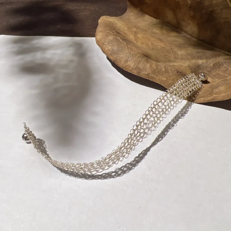 Open mesh bracelet woven from Fine Silver-Plated Copper Wire showing the woven band and round ball-style clasp detail