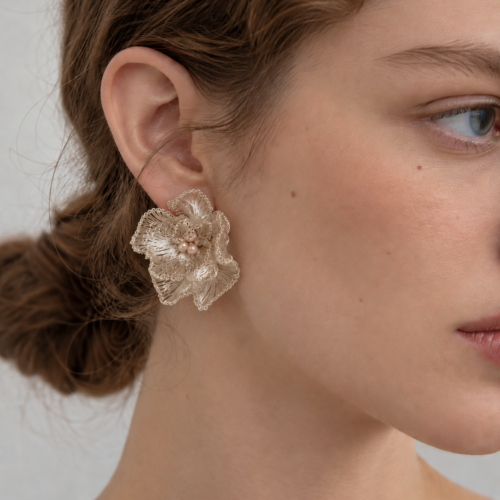 Model wearing OREYNE Cotton Rose sculptural stud earrings