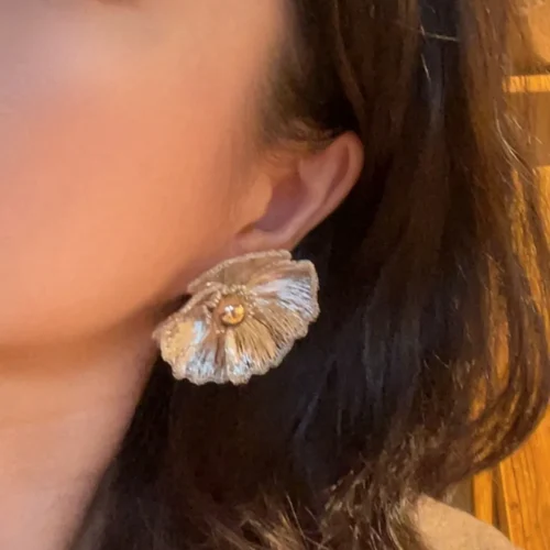 Model wearing OREYNE White Poppy sculptural stud earrings