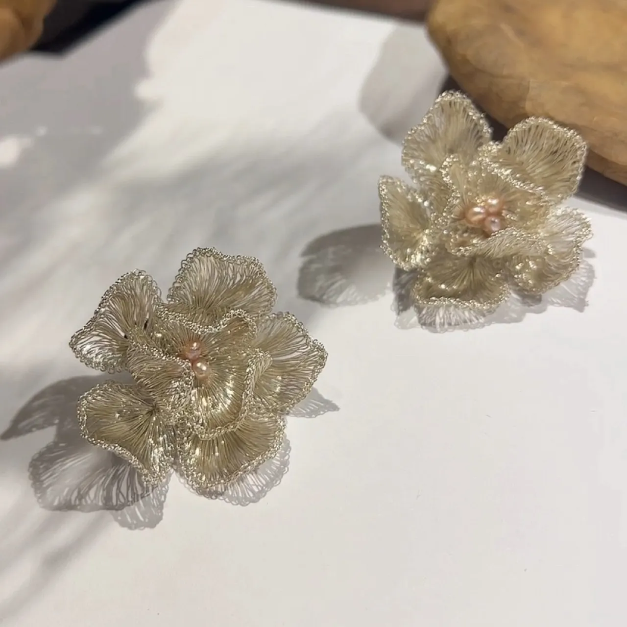 Close-up detail of OREYNE Cotton Rose sculptural flower stud earrings