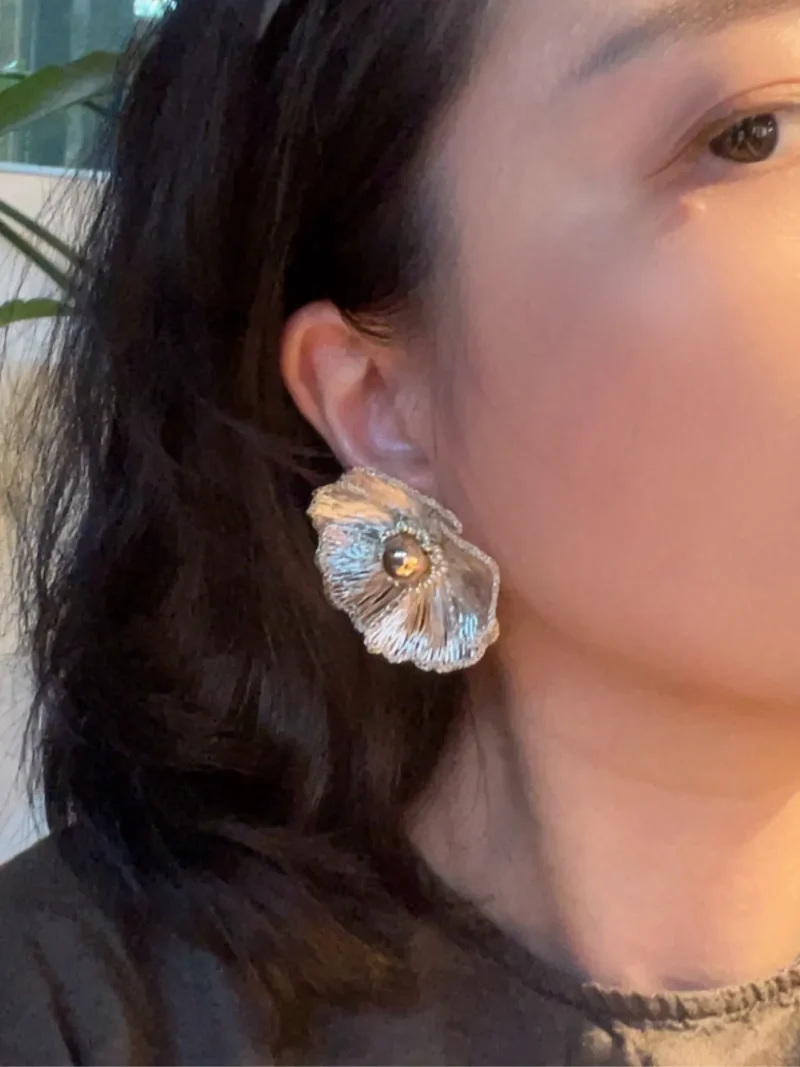 Close-up model view of OREYNE White Poppy stud earrings
