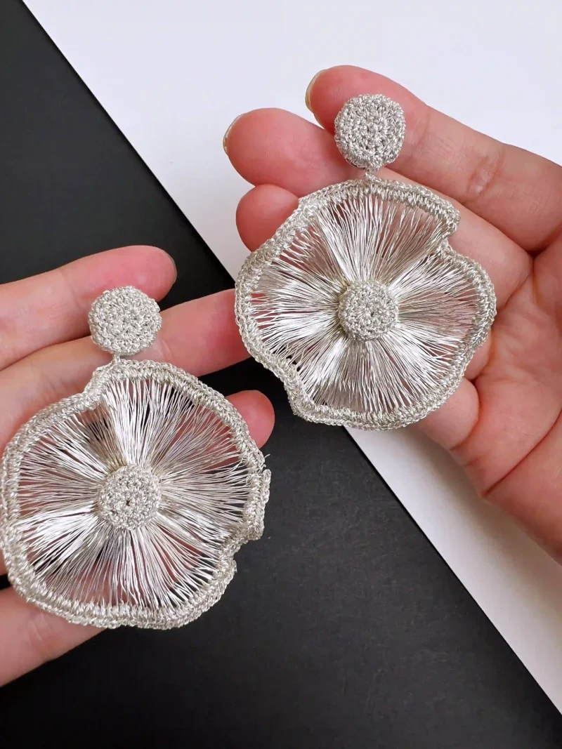 Handheld view of OREYNE Radiant Bloom statement earrings