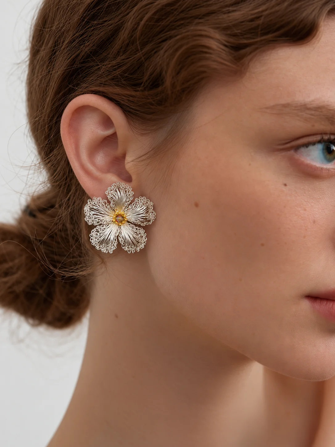 Model wearing OREYNE White Strawberry Blossom stud earrings