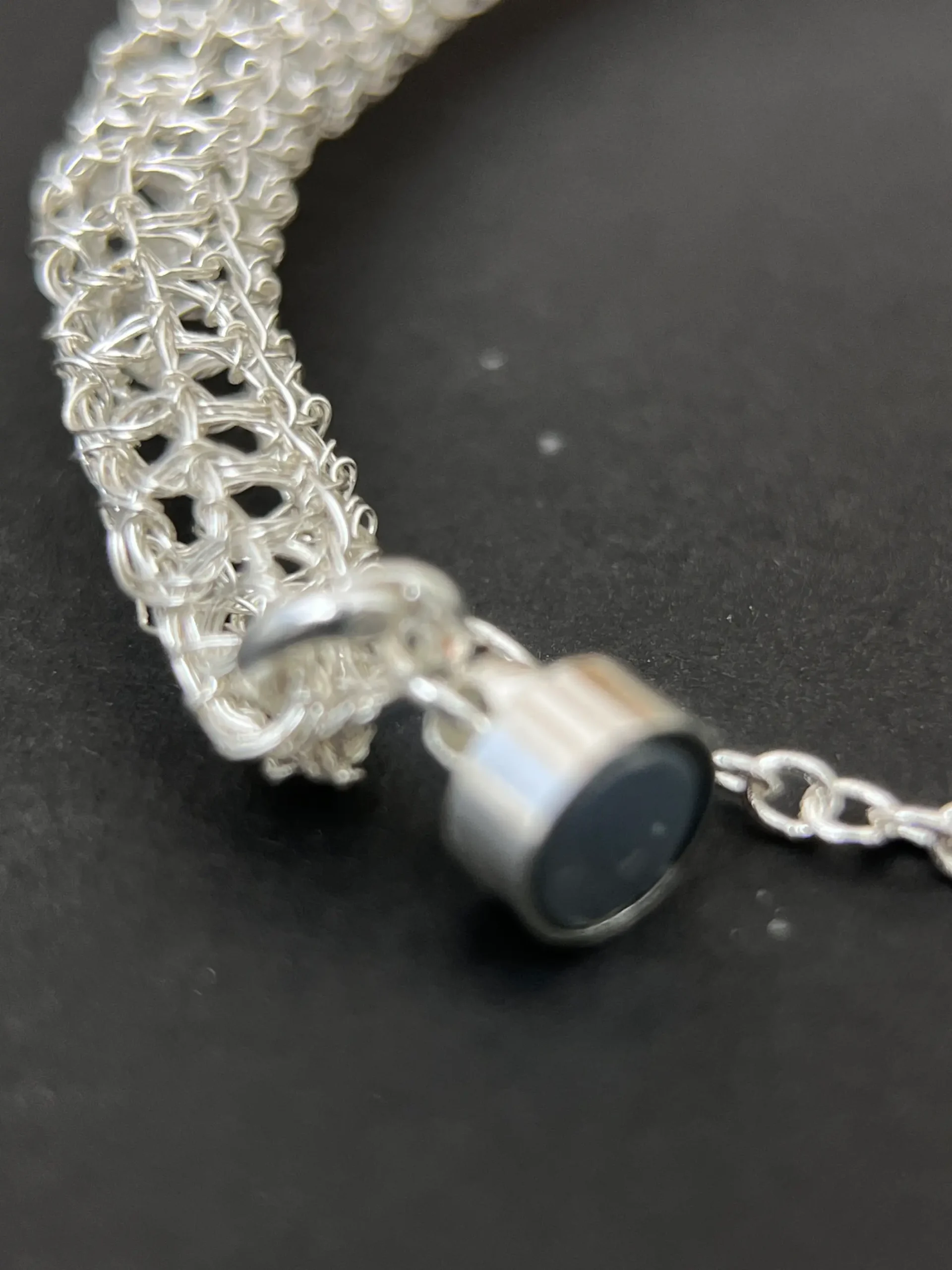 Close-up detail of the Woven Air silver mesh bracelet