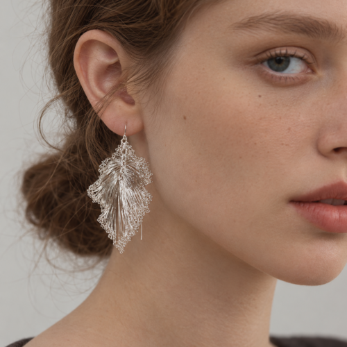 Model wearing OREYNE Ruffled Leaf drop earrings
