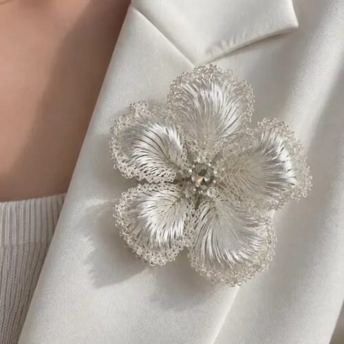 Model wearing OREYNE White Blossom sculptural brooch