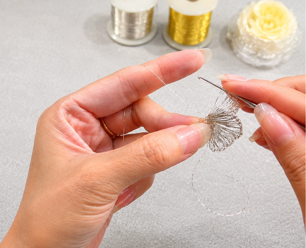 OREYNE jewelry being shaped and woven by hand in fine metal wire