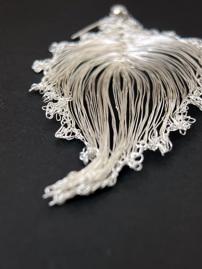 Close detail of handwoven wire lines in bodhi leaf earrings