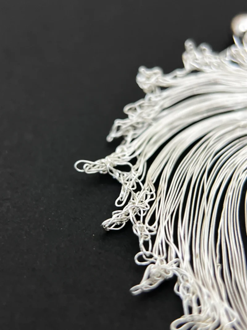 Close-up of the tapering handwoven wire leaf form